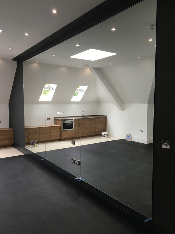 Frameless glass partition in loft conversion by Shoreditch glaziers